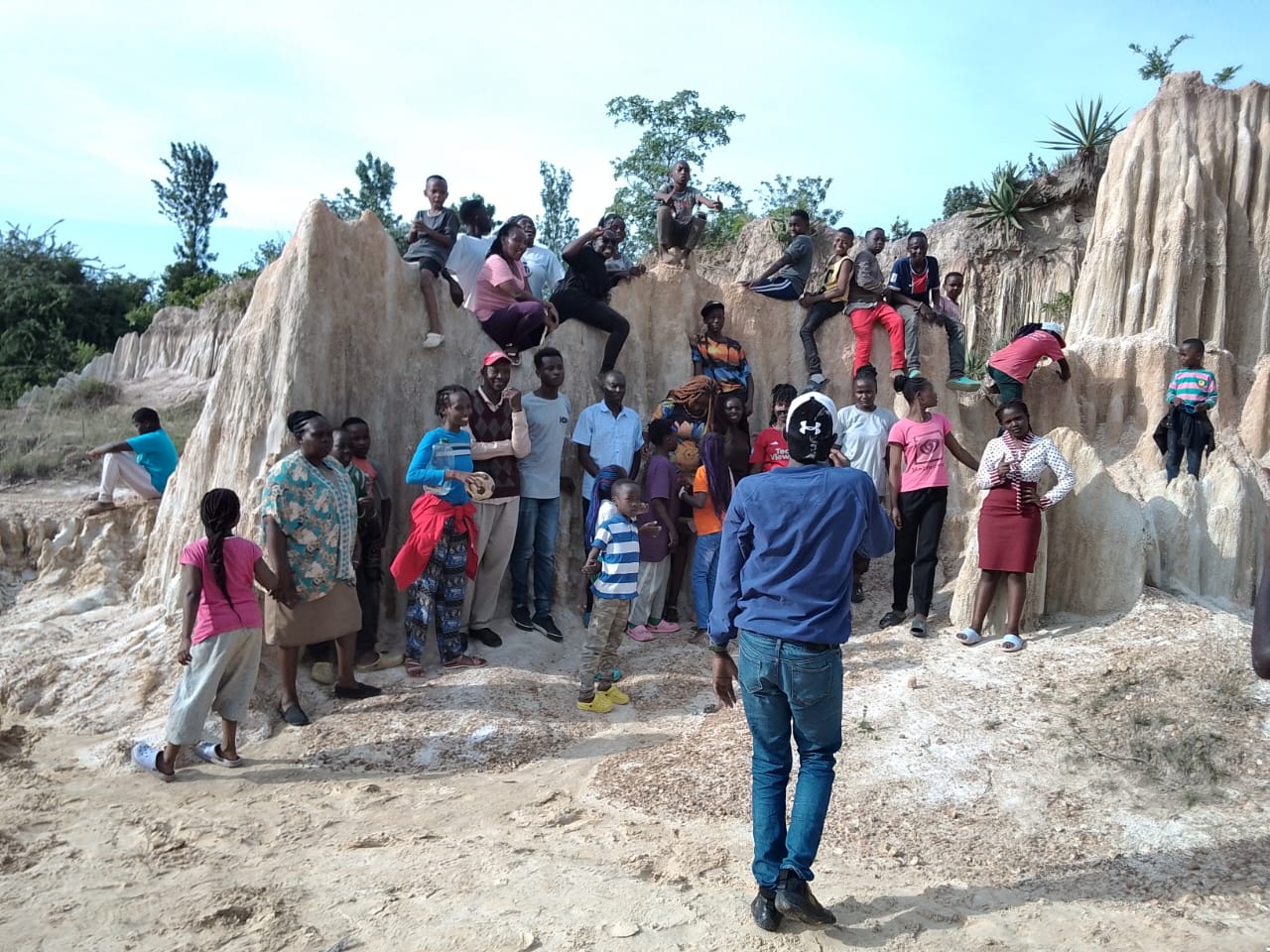 Children and staff on an outing at a rock formation