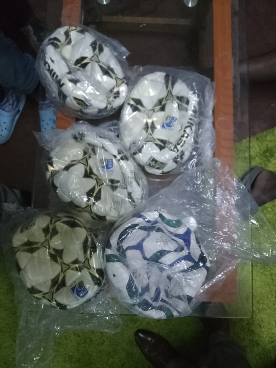 New footballs in plastic bags